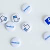 Photo of physical pins with the facebook logo and the like icon